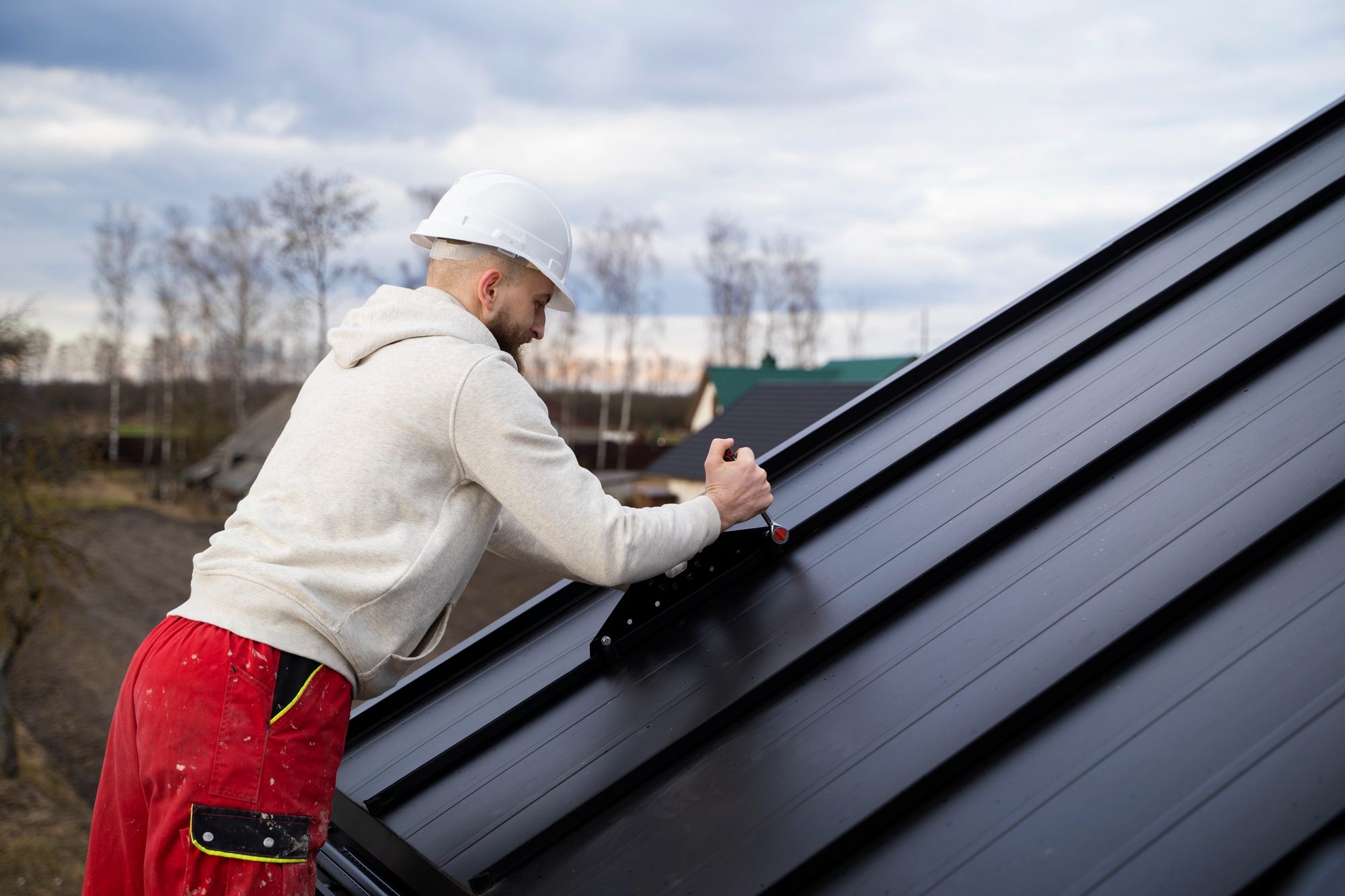 Man working on roof medium shot Man working on roof medium shot<br />